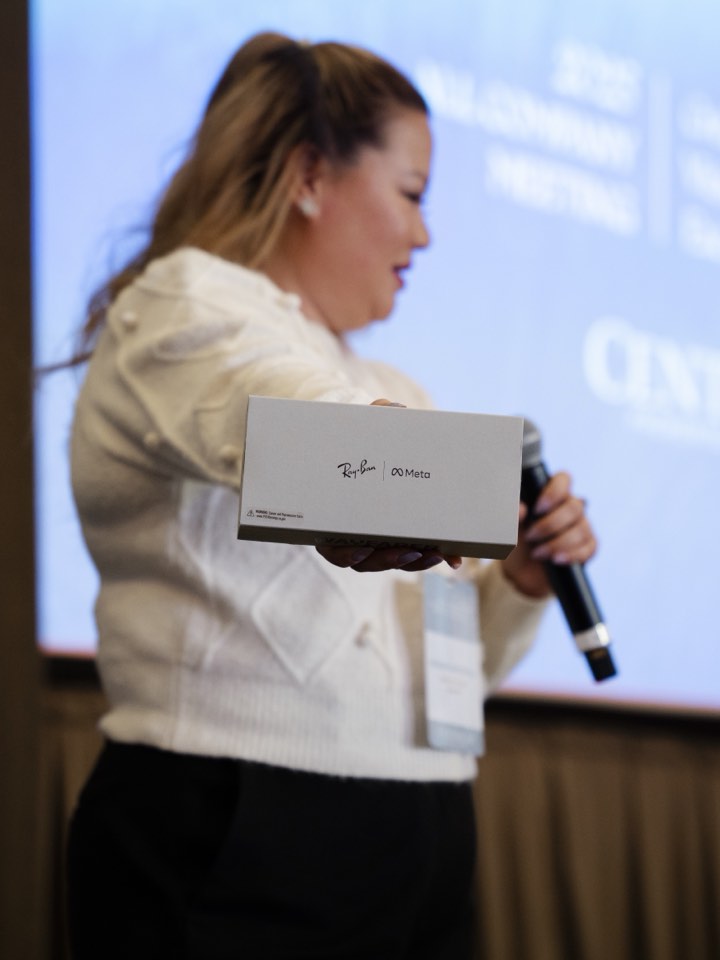Presenter holding a product up to the room