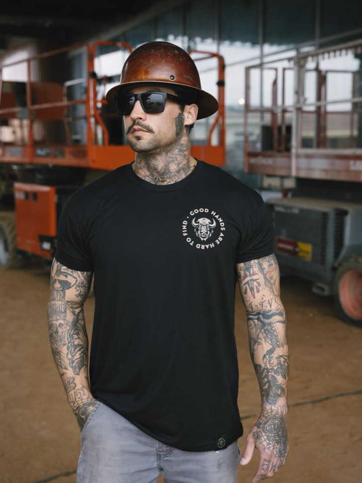 Business owner in branded apparel on site