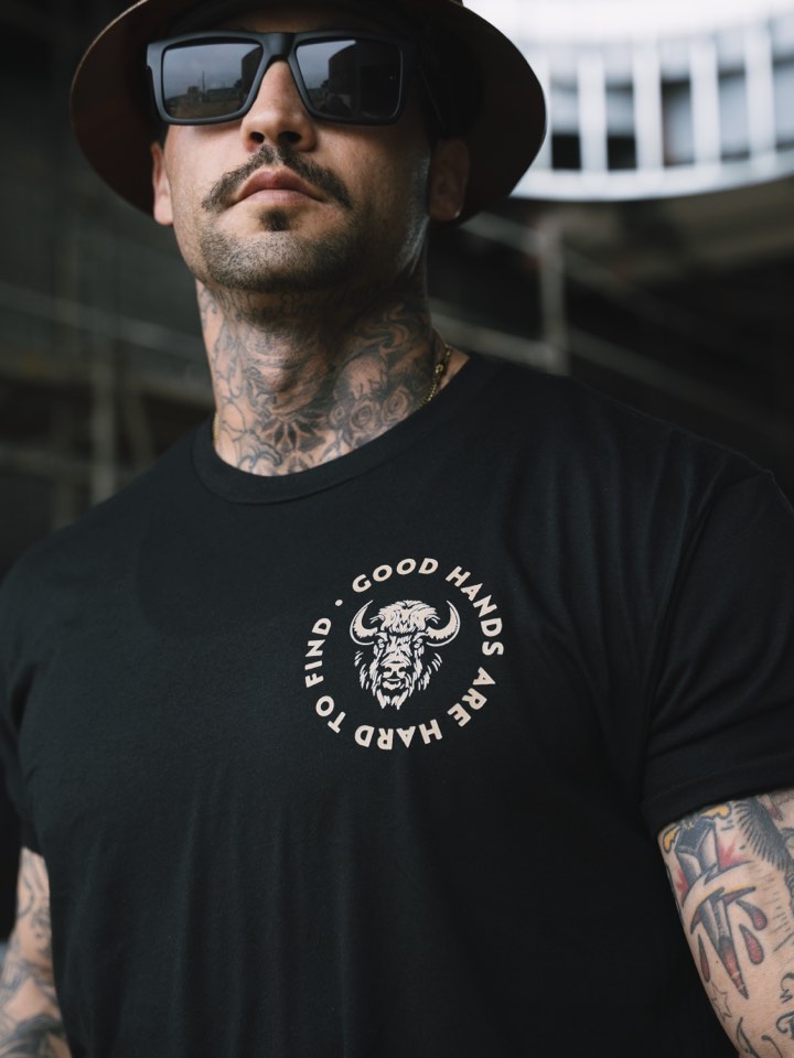 Portrait of a shop owner in a branded tee
