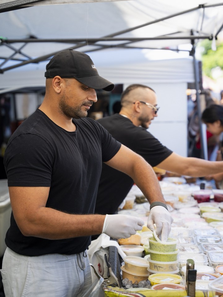 Vendor serving guests at a food activation