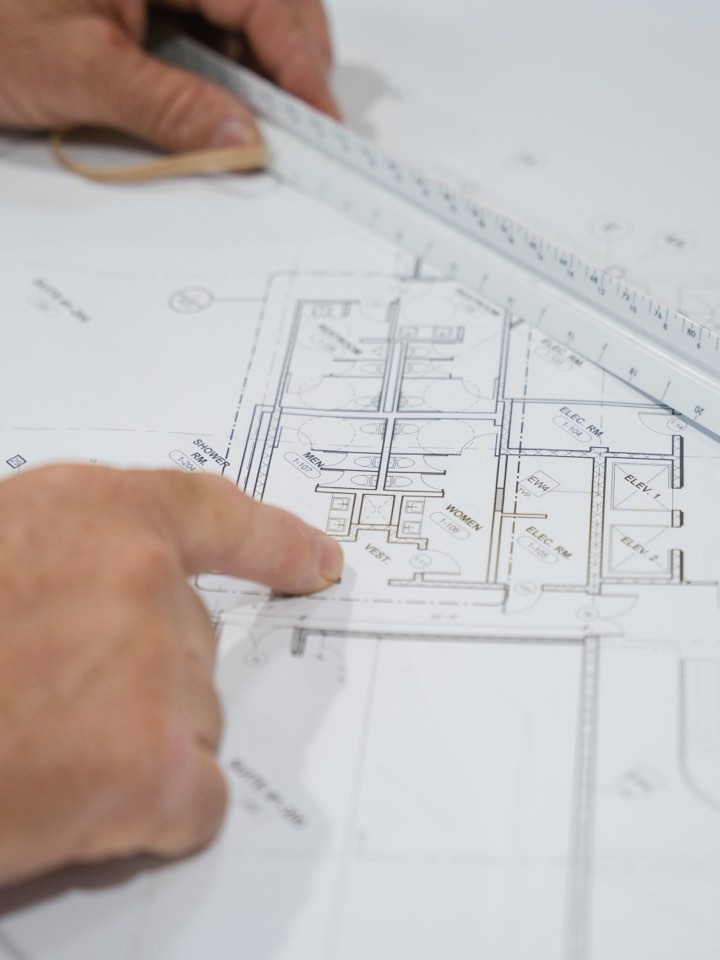 Hand tracing a detail on a set of plans