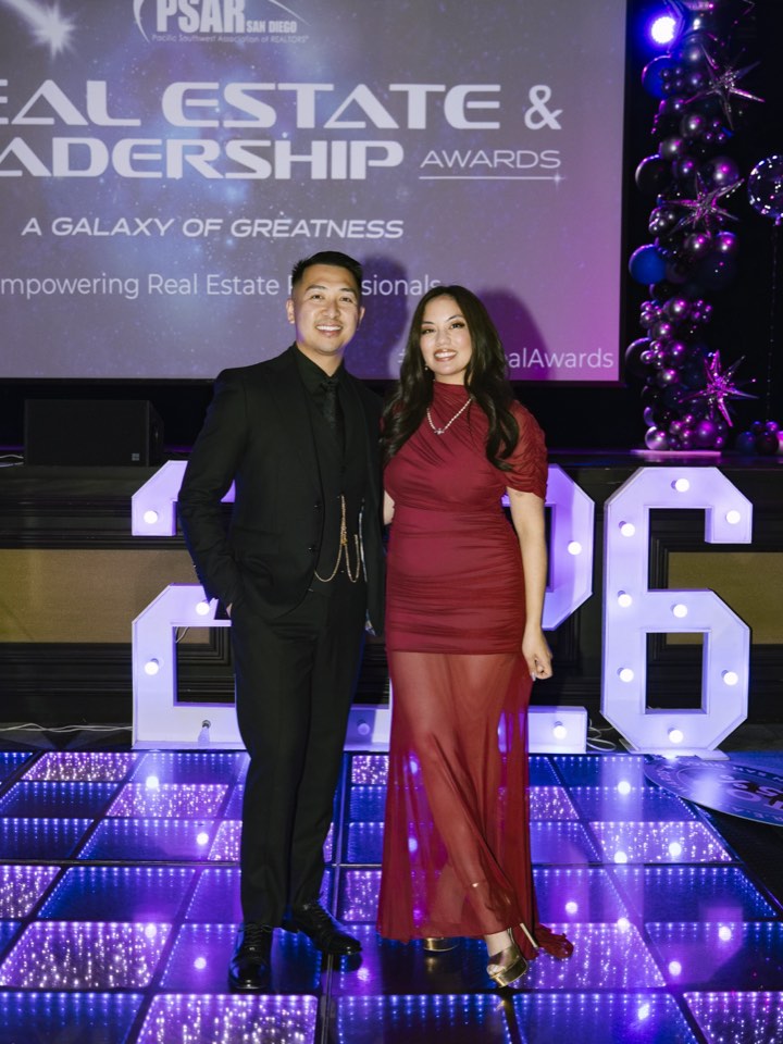 Hosts on stage at a real estate awards evening