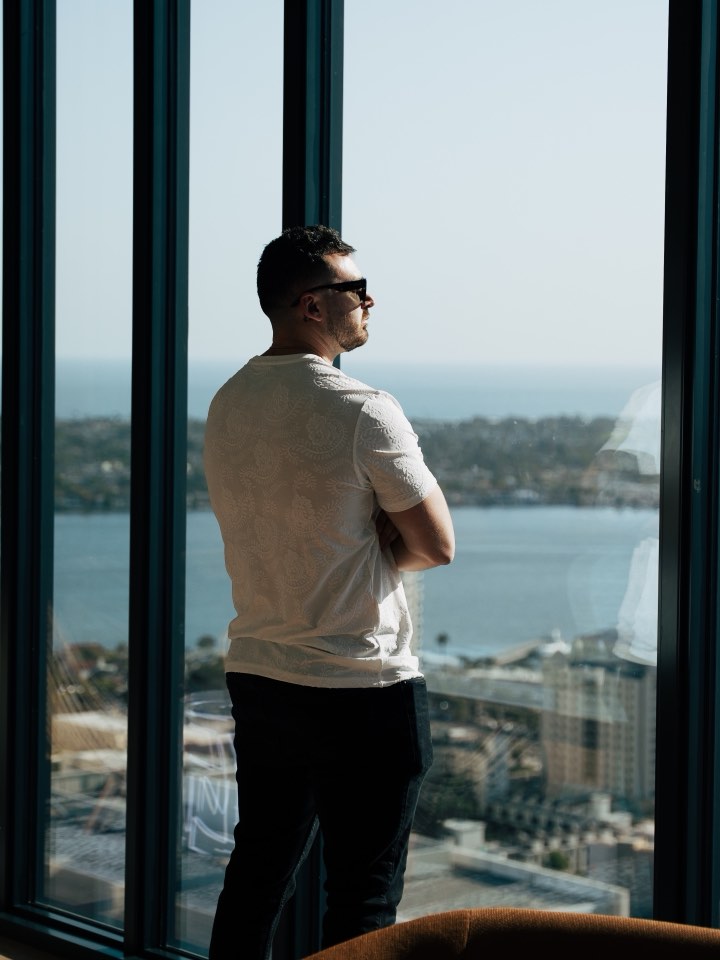 Portrait at a window with an ocean view behind
