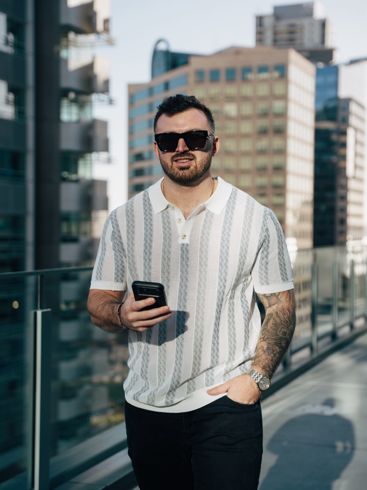 Rooftop portrait, phone in hand