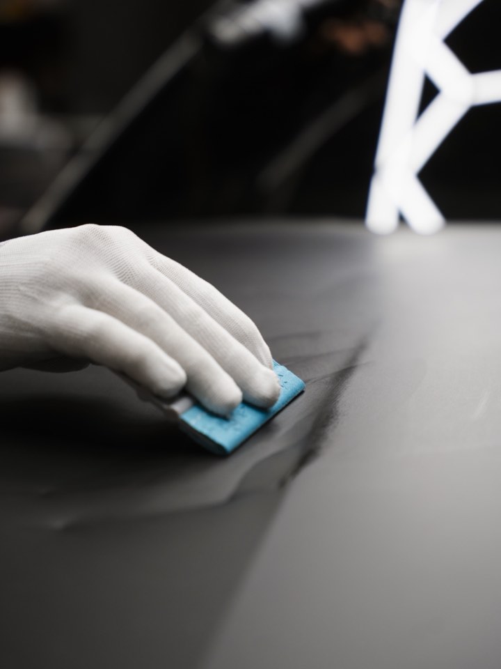 Close detail of a card being placed on a dark surface