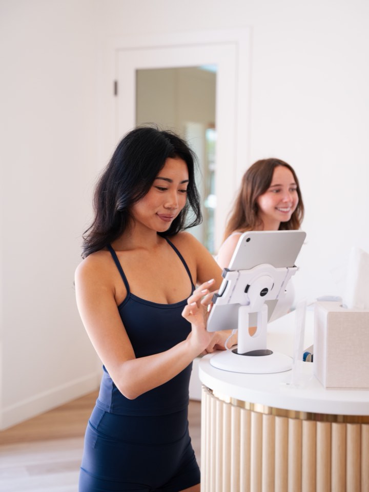 Client consultation over a tablet at the front desk