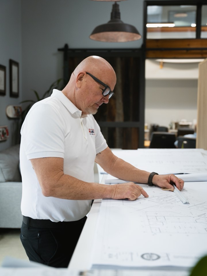 Owner walking a client through a set of plans