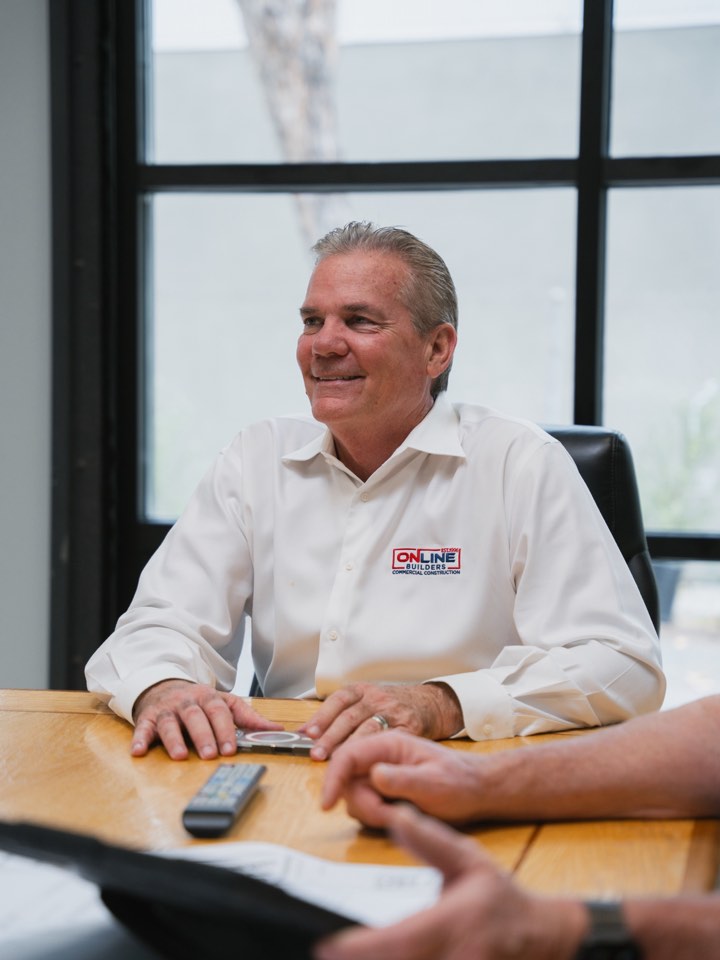 Business owner at his desk mid-conversation