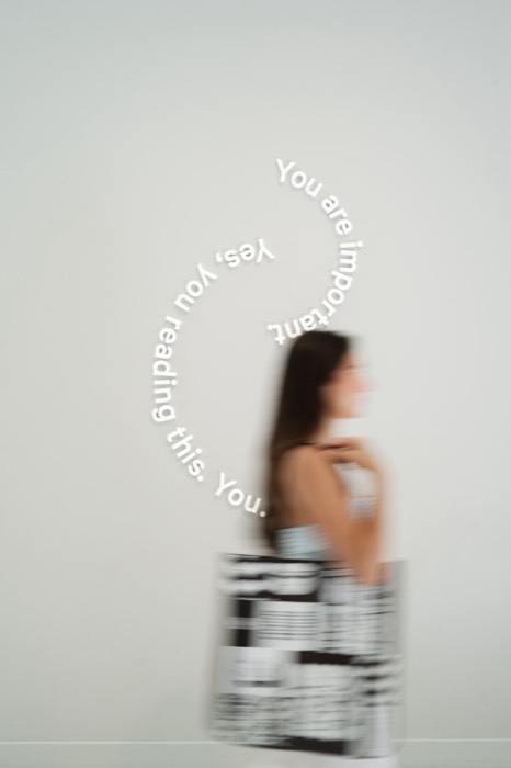 Motion-blurred tote shot against a studio wall